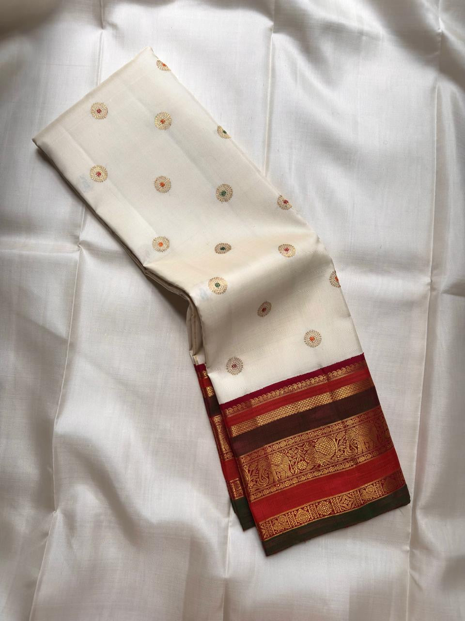 Ivory pure silk Kanchipuram saree, border selvedge detail with warm ivory with arakku-red, vermilion and manthulir-green accents