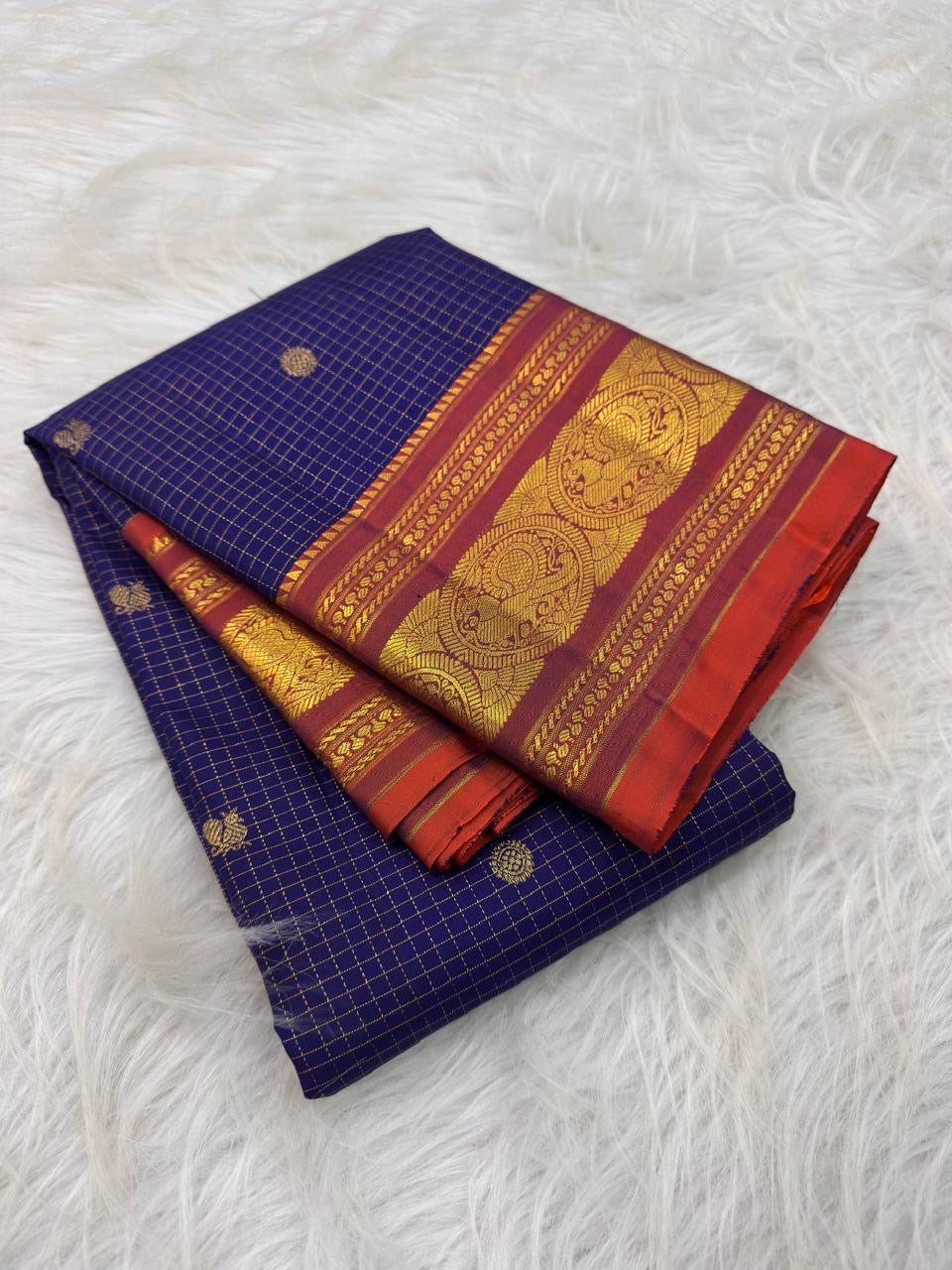 Deep Oodha blue Kanchipuram handloom silk Zari Kattam saree with copper-gold pallu draped for a sumangali prarthanai
