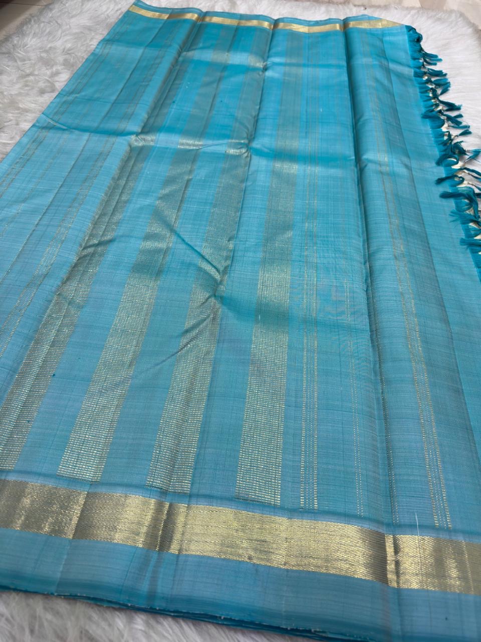 Warm ivory and Firozi blue slim-border Kanchipuram silk saree by Idam Living