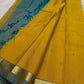 Turmeric yellow Pure Kanchipuram Silk saree with peacock blue pallu, slim gold zari border and delicate teal buttas