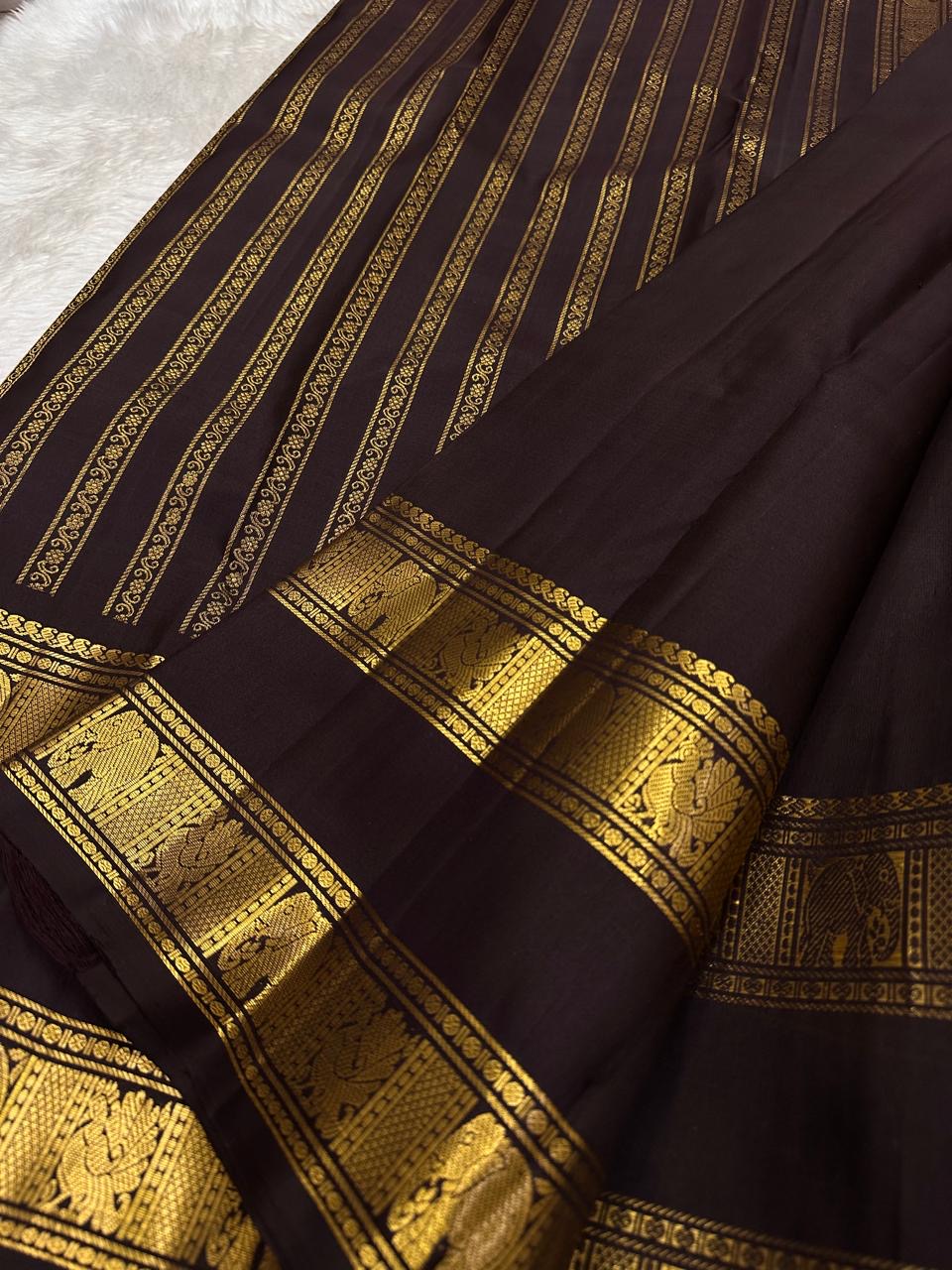 Deep plum Kanchipuram saree with a pallu of fine parallel gold zari lines