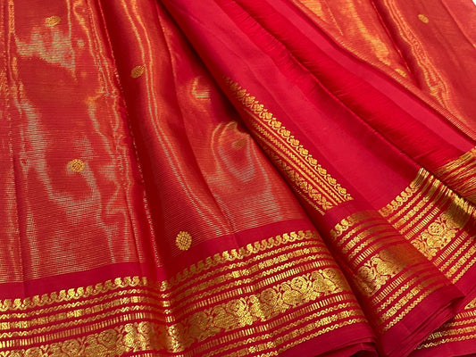 Pure Kanchipuram silk saree in kunkumam red with vairaoosi weave texture and kamalam butta lotus motifs in traditional gold zari