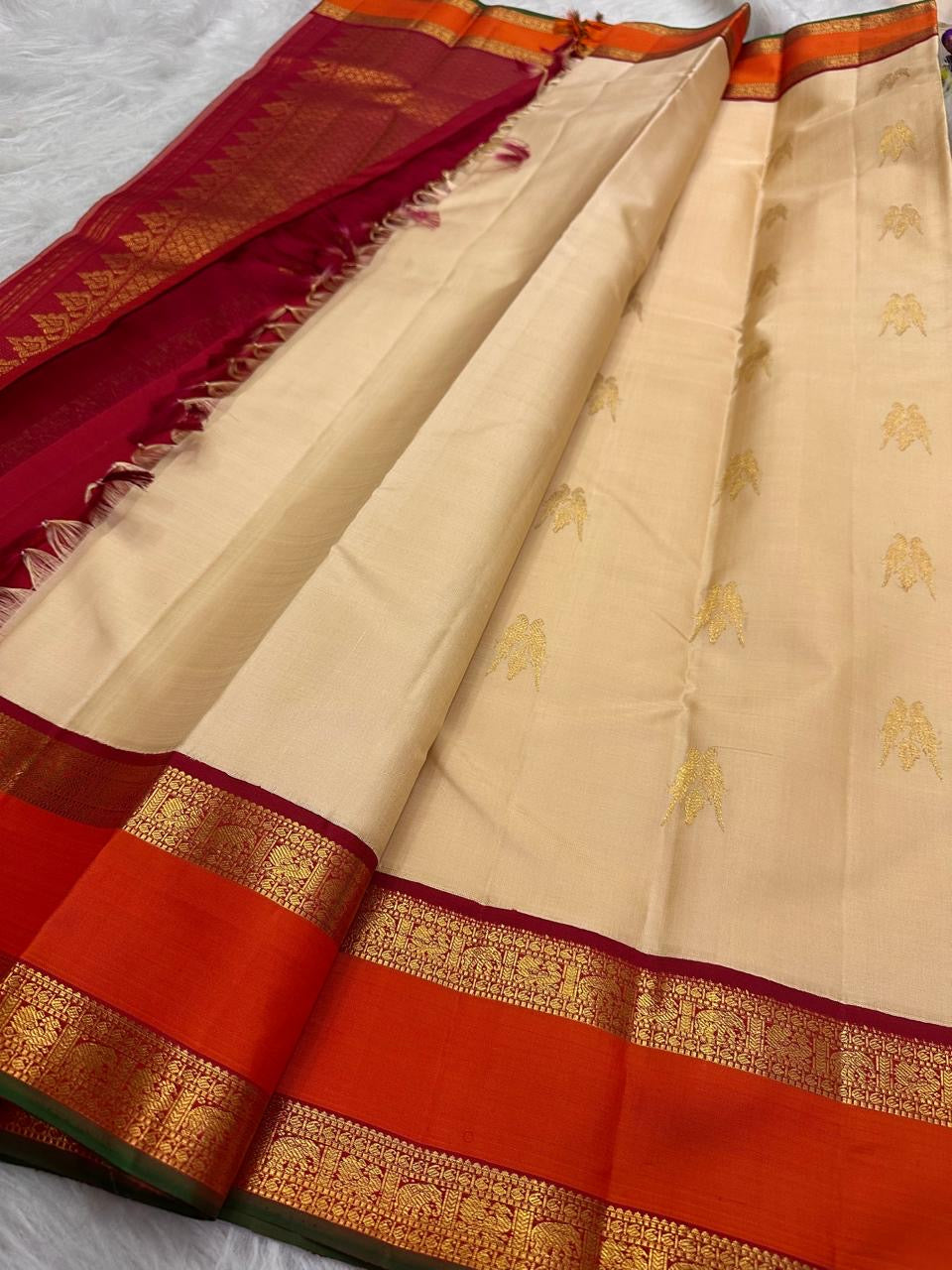 Sandalwood ivory handwoven pure silk Kanchipuram Kai Korvai saree with gold zari twin parrot buttas and raspberry-red border