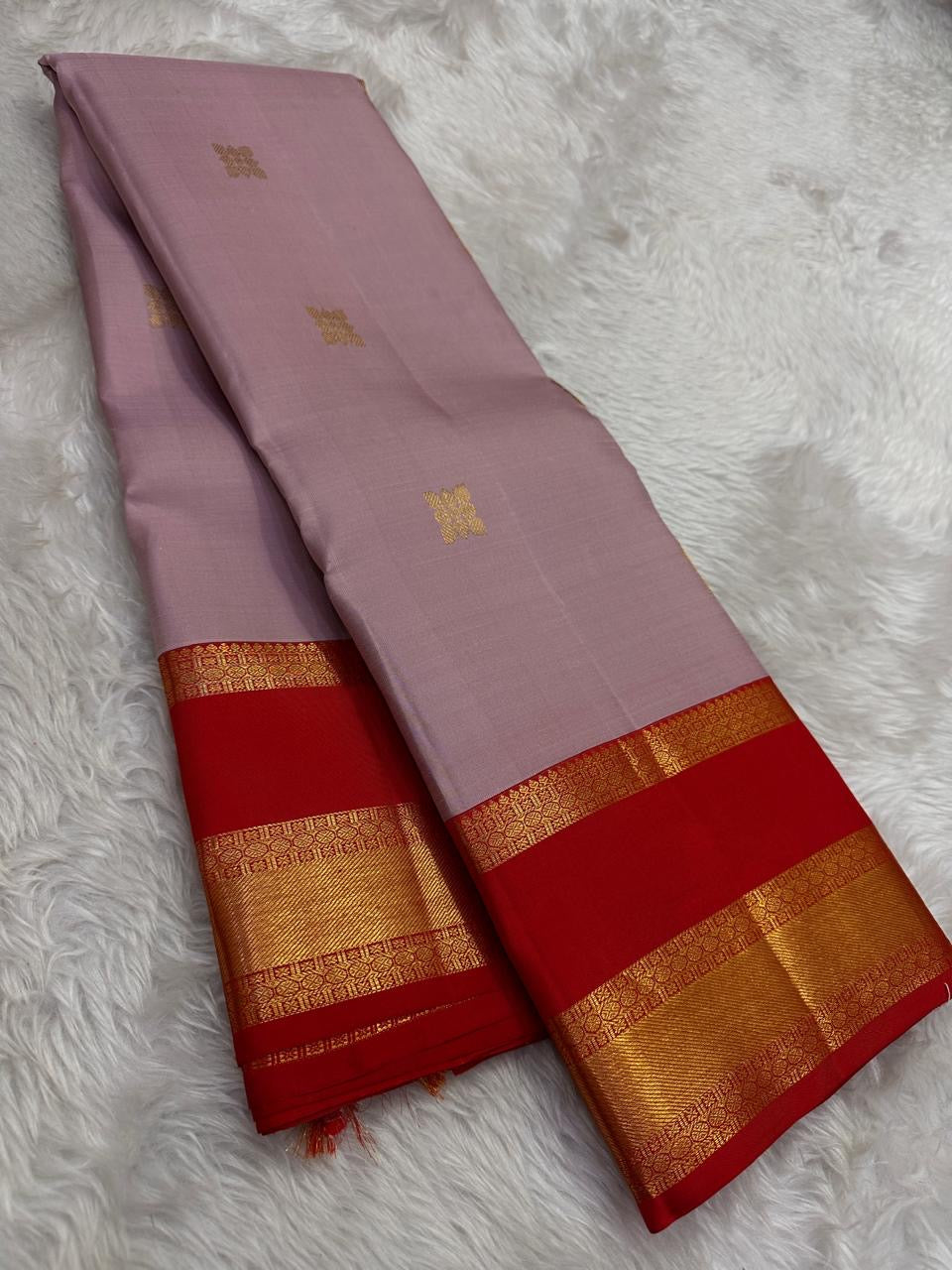 Kamalam floral motifs and scrolling Kodi vine zari border on Kanchipuram silk
