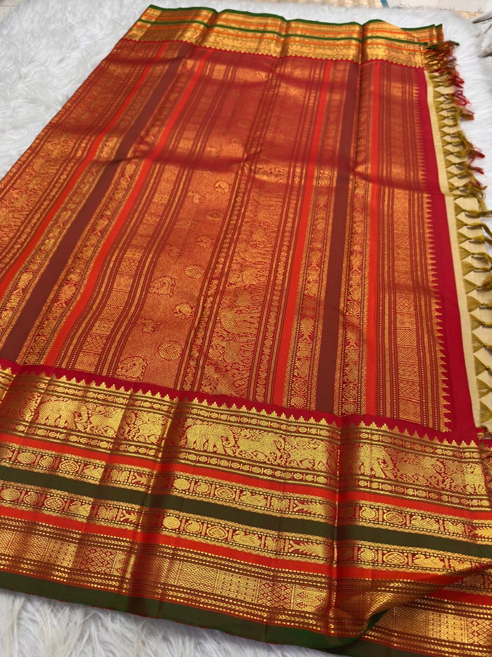 Sandalwood ivory Kanchipuram saree with ornate red zari pallu.
