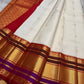 Warm ivory Kanchipuram silk saree with delicate gold zari buttas