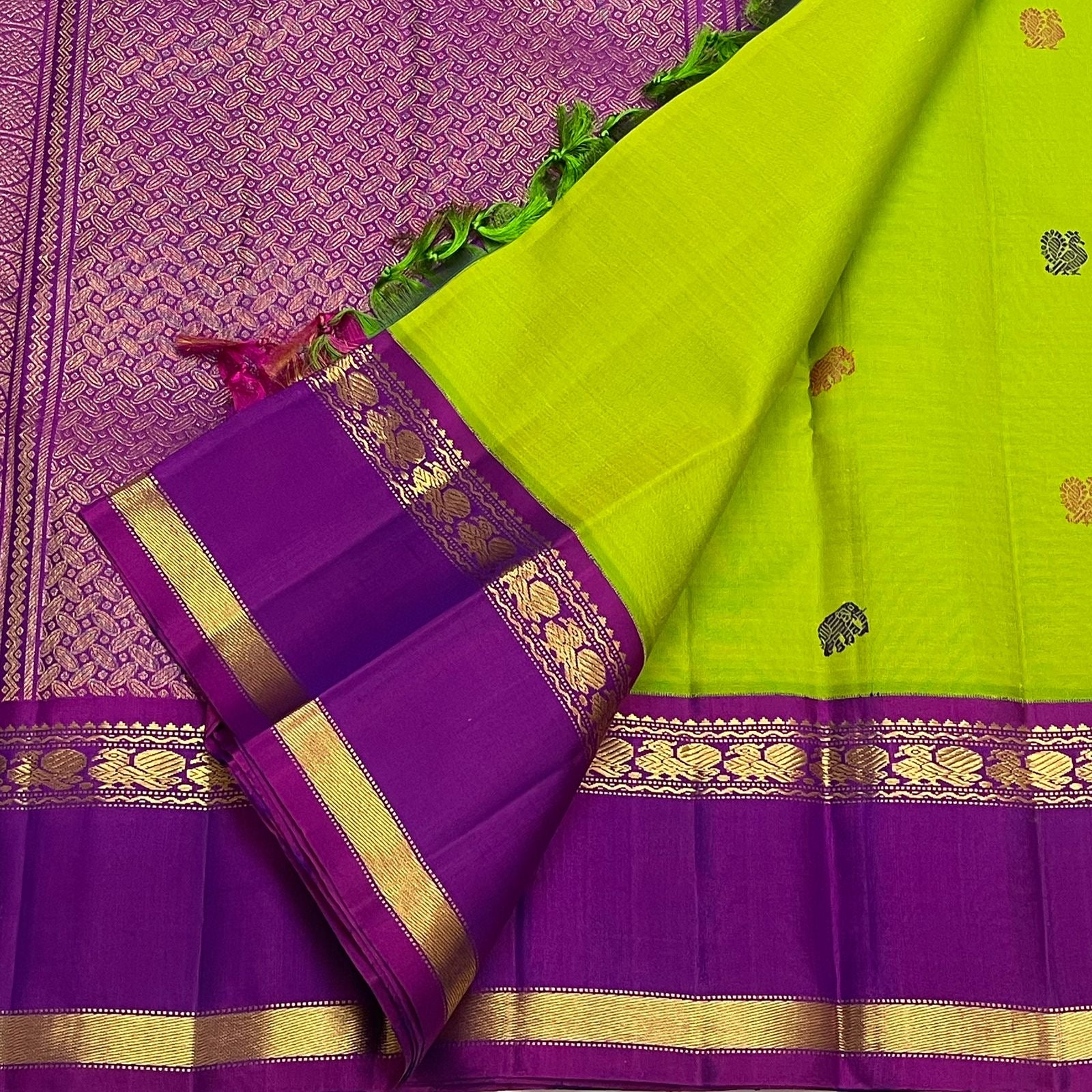 Kanchi silk saree chartreuse body with fine motif placement and rich violet contrast border draped view