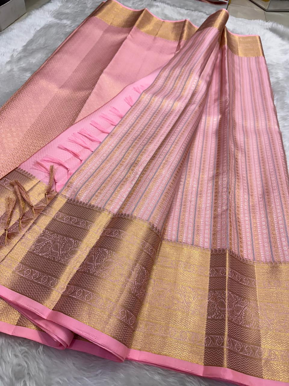 Petal pink silk saree with gold buttas and apricot border draped view
