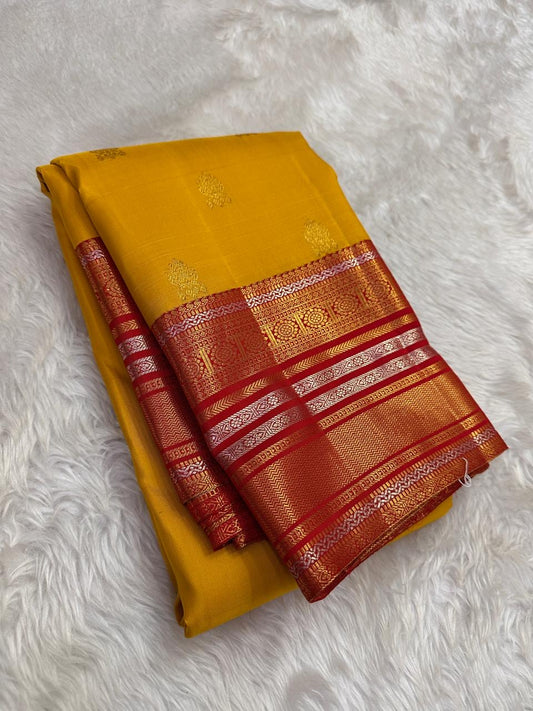 Marigold yellow Kanchipuram silk saree with vermilion red border folded view