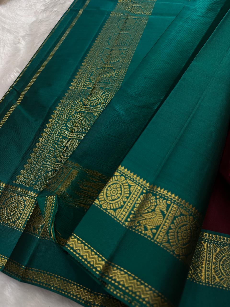 Arakku maroon and peacock teal pure silk saree with an ornamental teal pallu