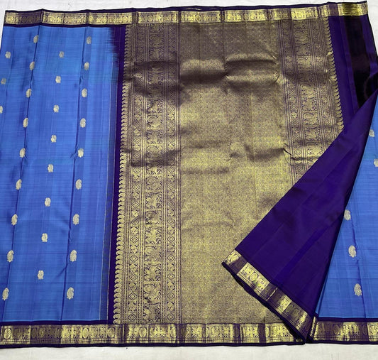 Azure blue Kanchipuram silk saree folded view with indigo purple korvai border and gold zari butta