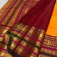 Marigold orange Kanchipuram silk saree body with gold buttas.