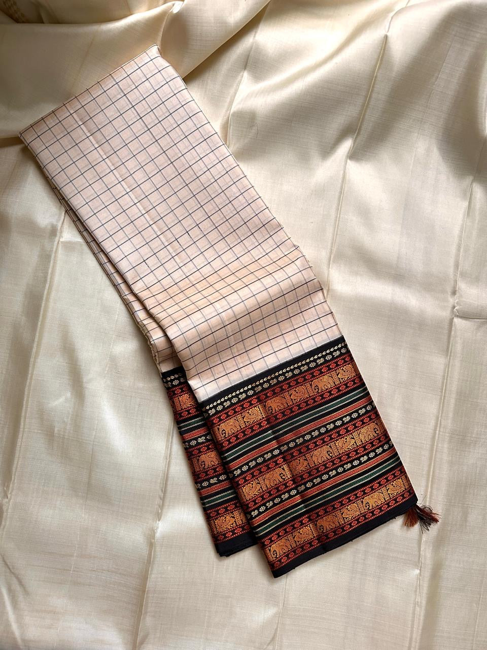 Pure Kanjivaram saree in ivory black featuring checkered kattam grid with intricate silk thread motif work across the body