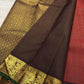 Smoky plum-brown pallu with dense old-gold floral latticework and fine zari stripes on vermilion red Kanchipuram saree