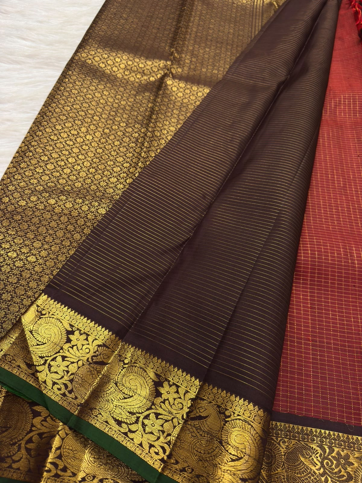Smoky plum-brown pallu with dense old-gold floral latticework and fine zari stripes on vermilion red Kanchipuram saree