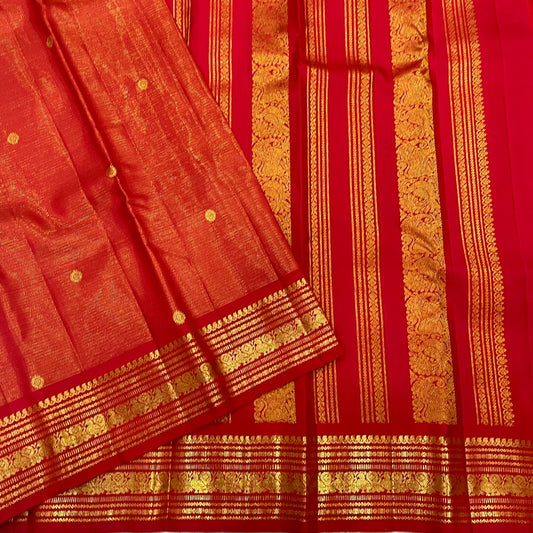 Close view of kunkumam red Kanchipuram silk saree showing vairaoosi zari line texture and lotus kamalam butta motif placement