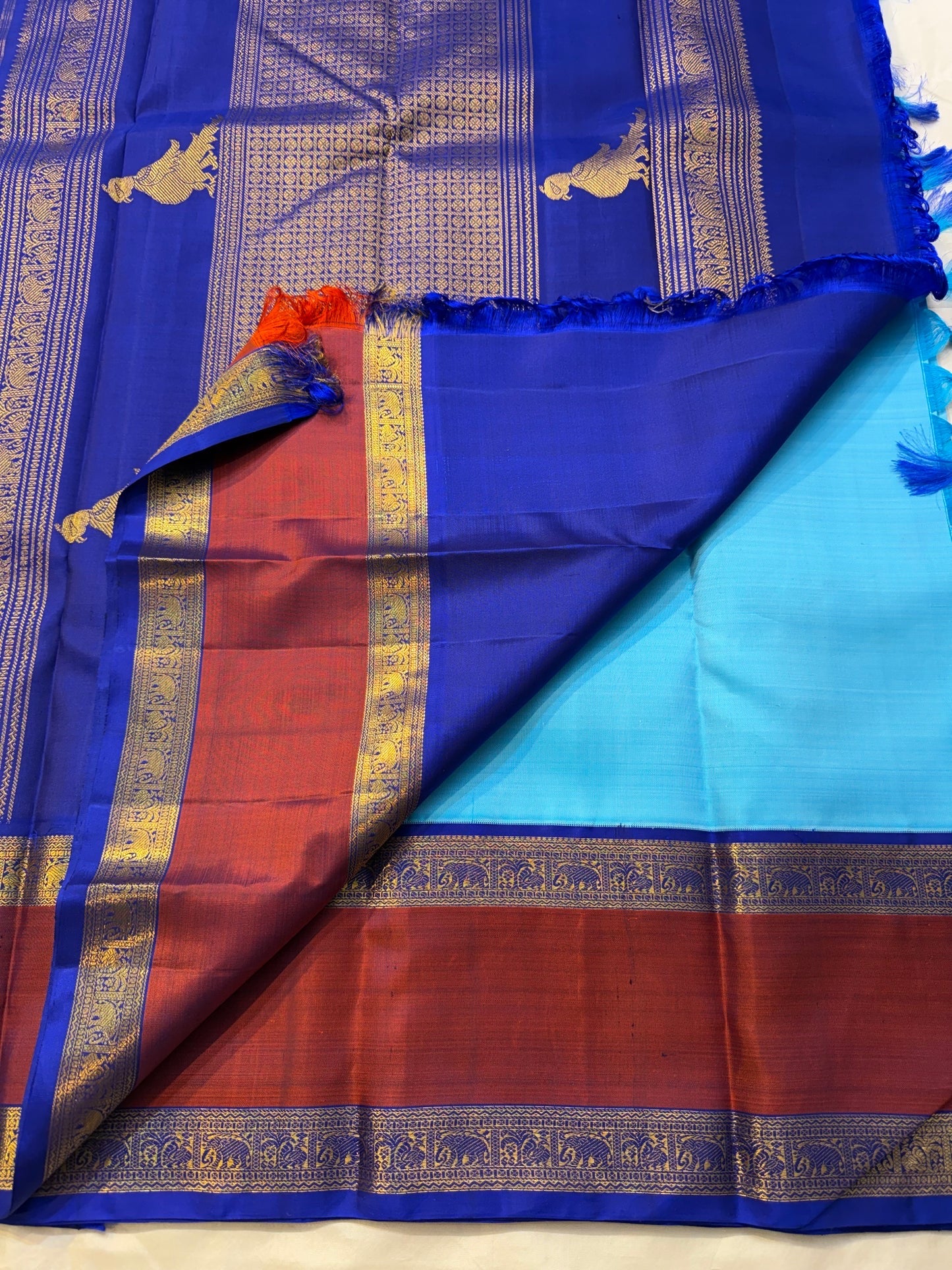 Grand zari peacock pallu detail on turquoise blue pure silk Kanjipuram saree