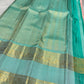 Close-up of antique gold zari buttas on blush rose Kanjivaram silk saree body