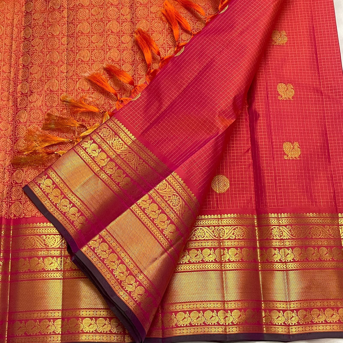 Varisaipet border with Rudraksham detail on a coral and sunset orange Kanchipuram Zari Kattam saree