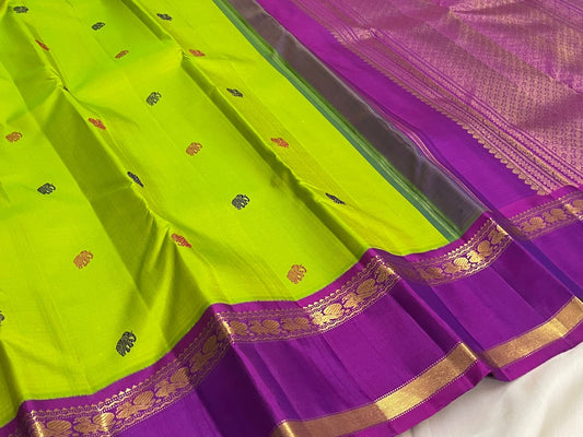 Kanchipuram silk saree in chartreuse with mayil butta motifs and royal violet rettapet zari border folded view