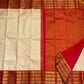 Flat-lay ivory pure Kanchipuram silk saree with rich red zari woven pallu and border, shipped from New Jersey USA.