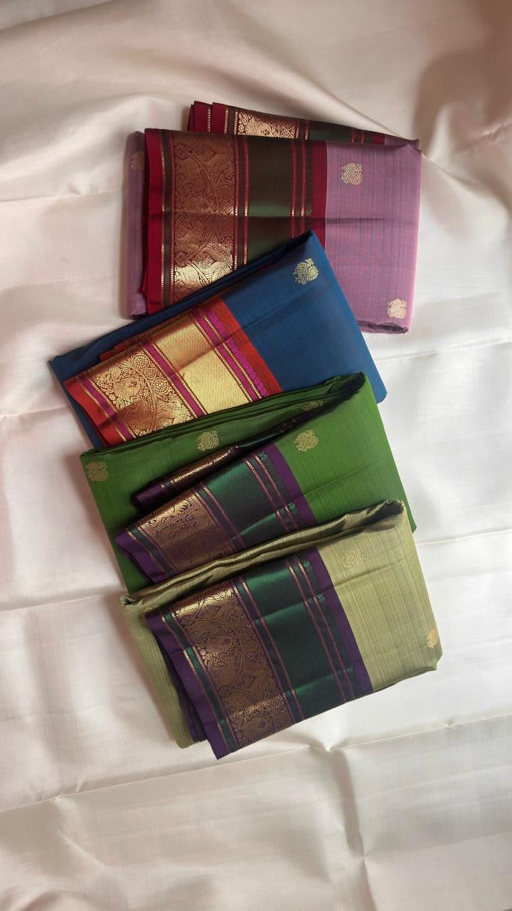 Emerald green and aubergine-purple Vanasringaram peacock border on leaf green Kanjivaram saree