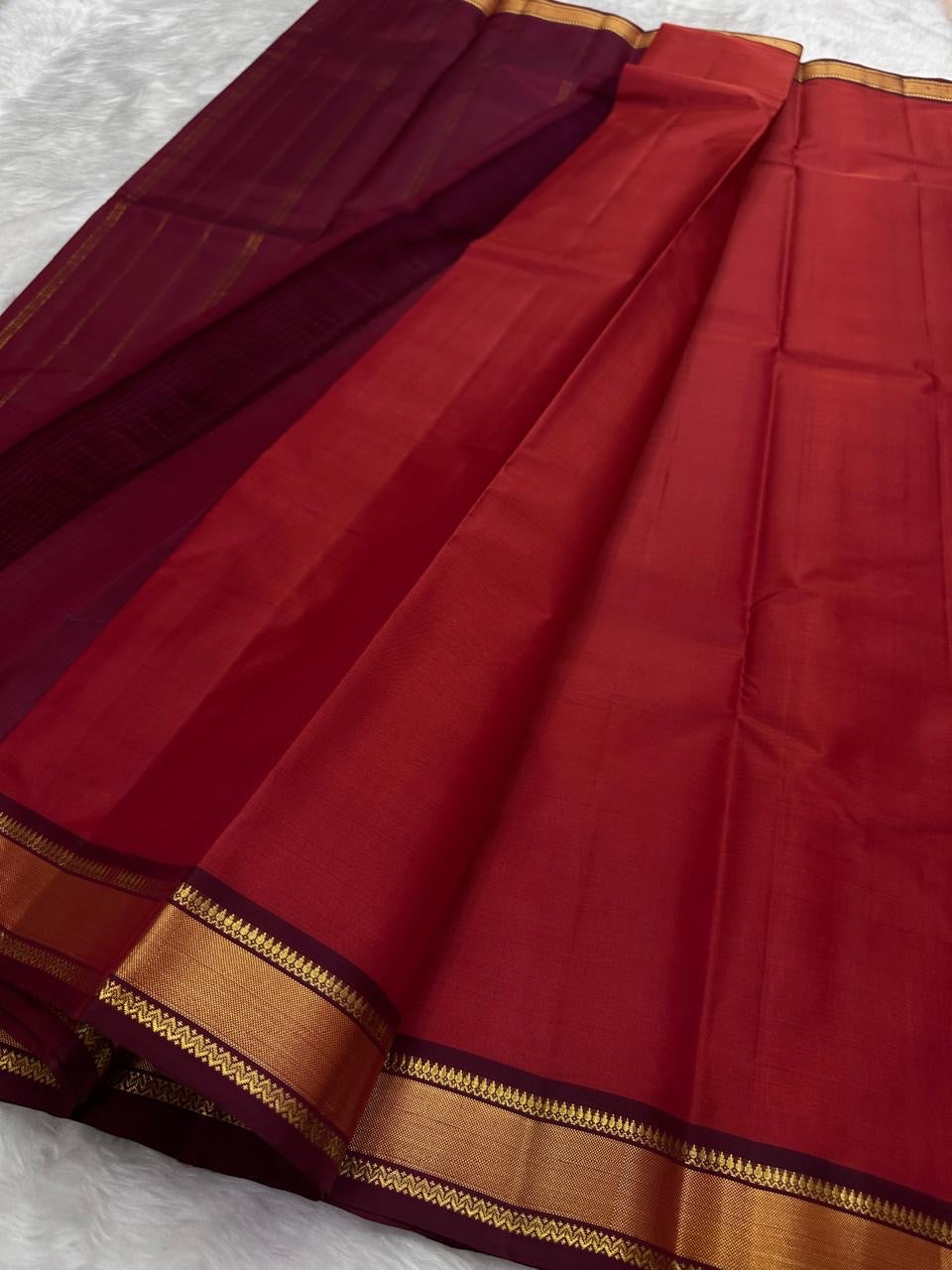 Brick Red and Deep Arakku Maroon lightweight Kanchipuram silk saree, broad gold zari border and striped maroon pallu; body detail