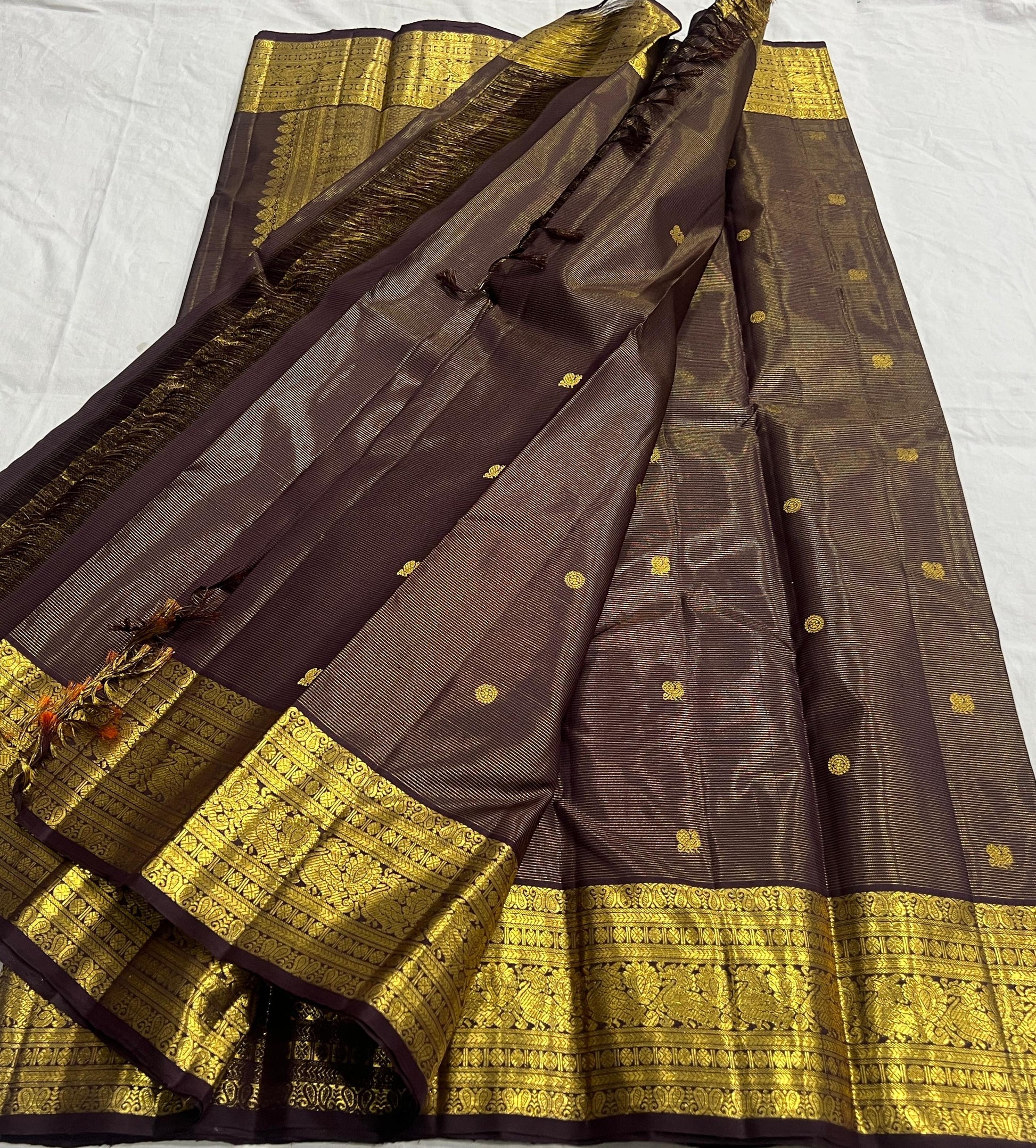 Kanchipattu silk saree with antique gold pallu and brown silk body closeup