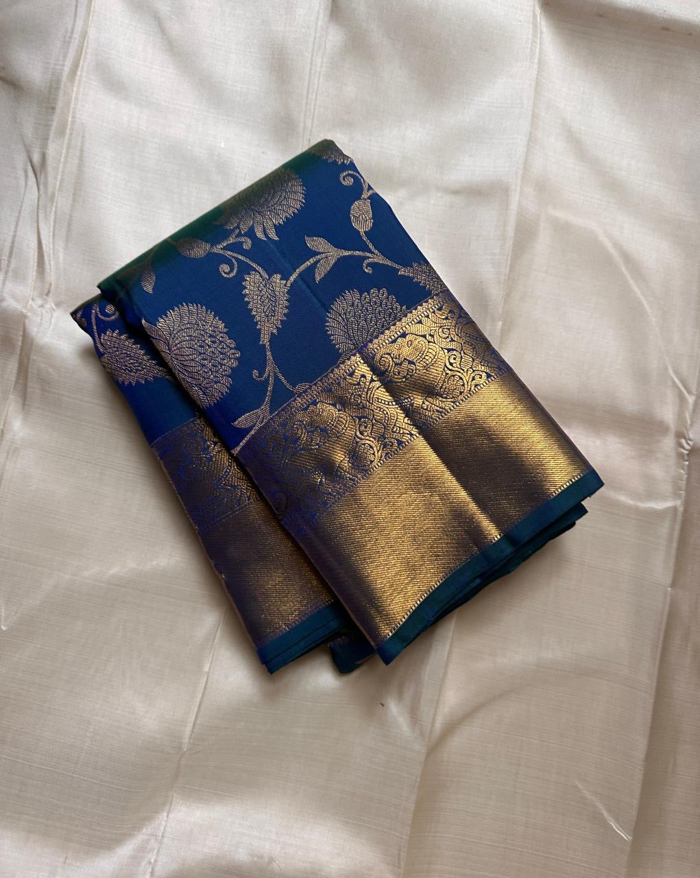 Blue Kanjivaram silk saree with floral butta jaal design draped view