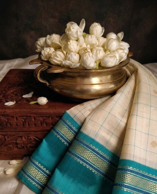 Blush pink Kanchipuram silk saree with kanchi kattam checks and navy blue zari border folded view