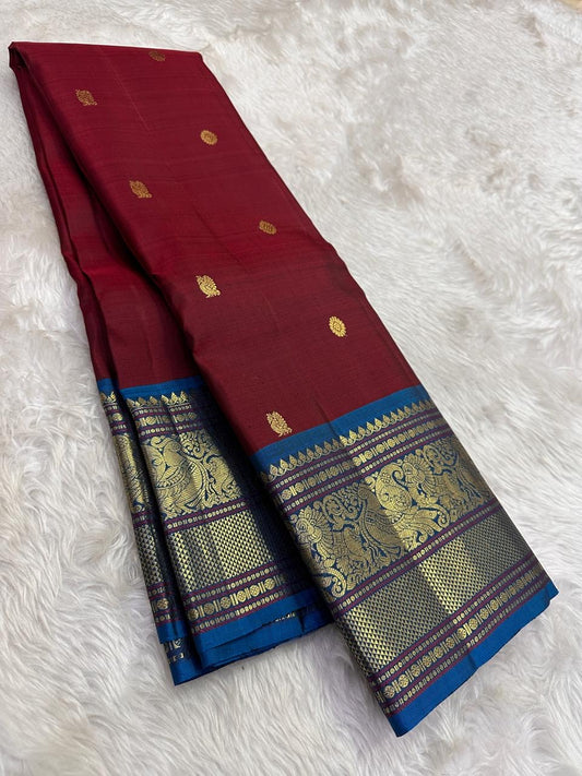 Pure Kanchipuram Silk Saree Burnished Ruby with Indigo Korvai Border and Mayil Butta