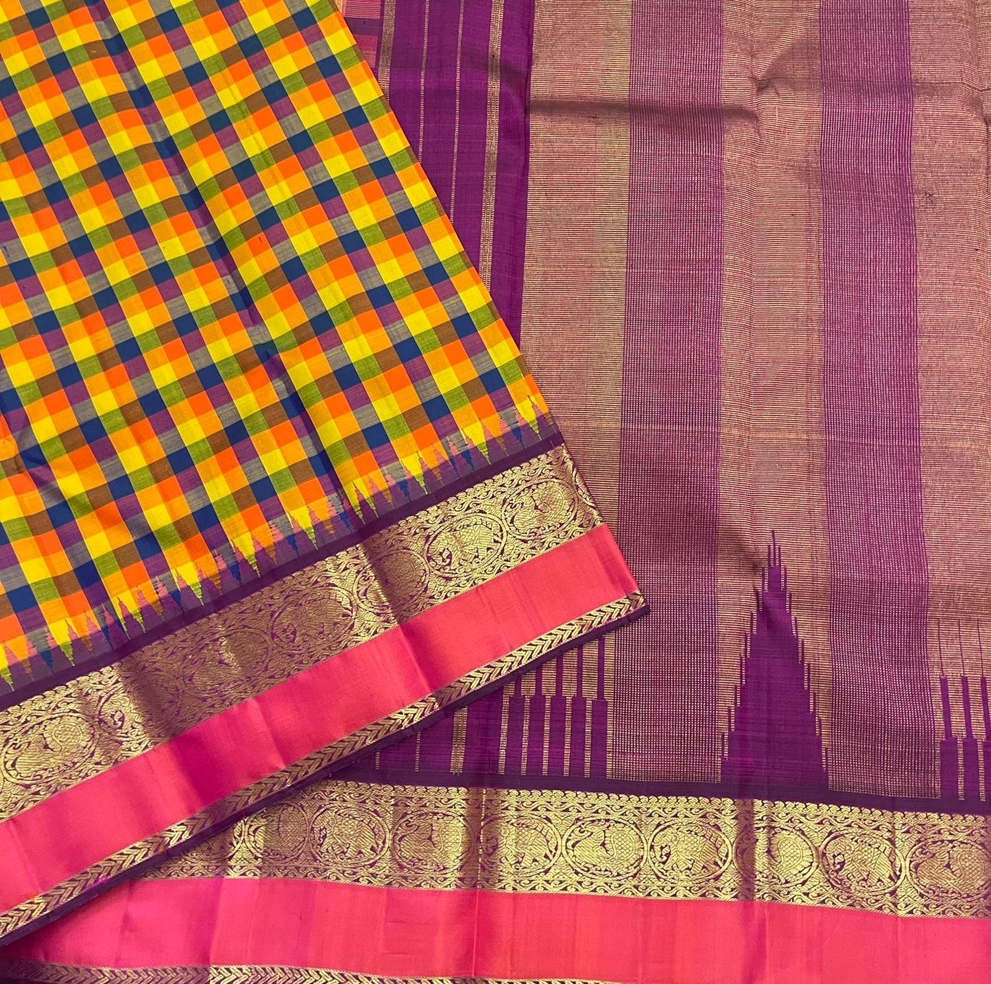 Detailed view of multicolor checked handloom silk body transitioning into purple border with gold zari