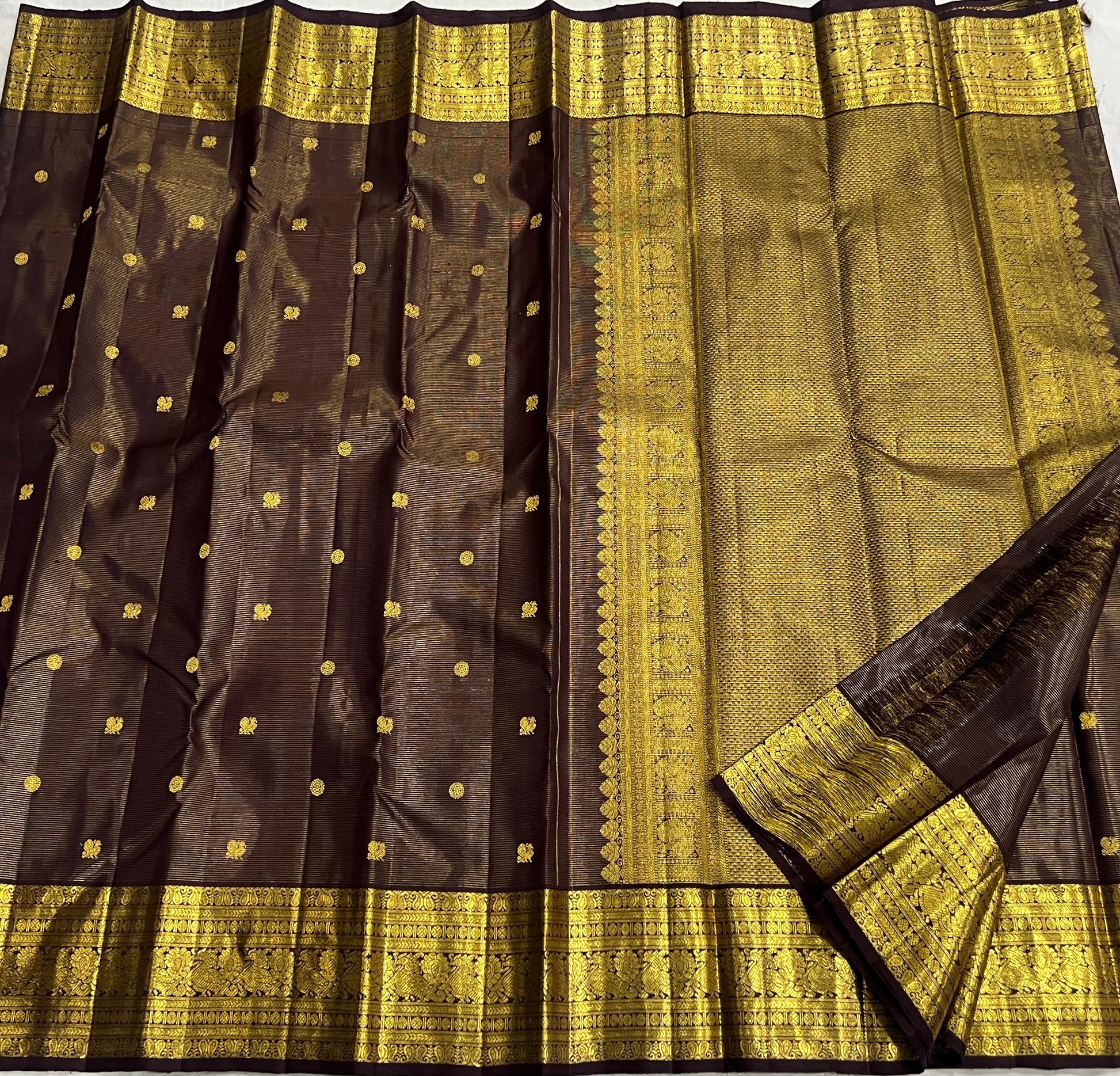 Kanjeevaram silk saree with linear zari texture and rich gold pallu detail