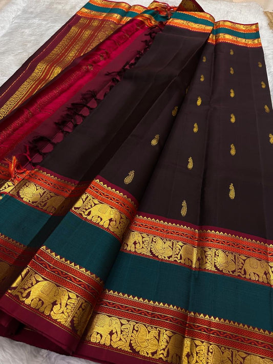 Brown Kanjivaram saree with green rettapet zari border detail close up