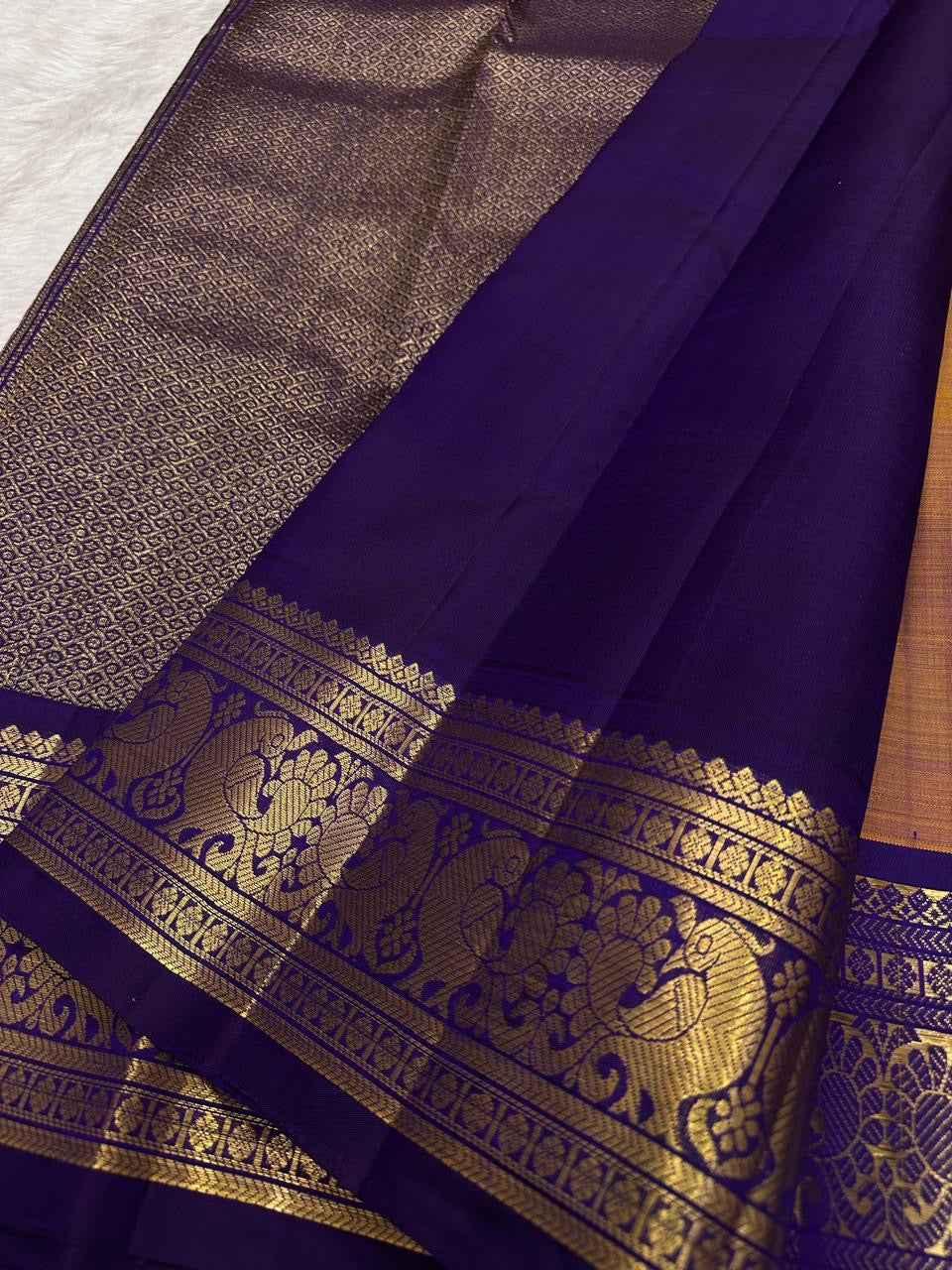 traditional tested zari detail on burnt copper Kanchipuram silk saree