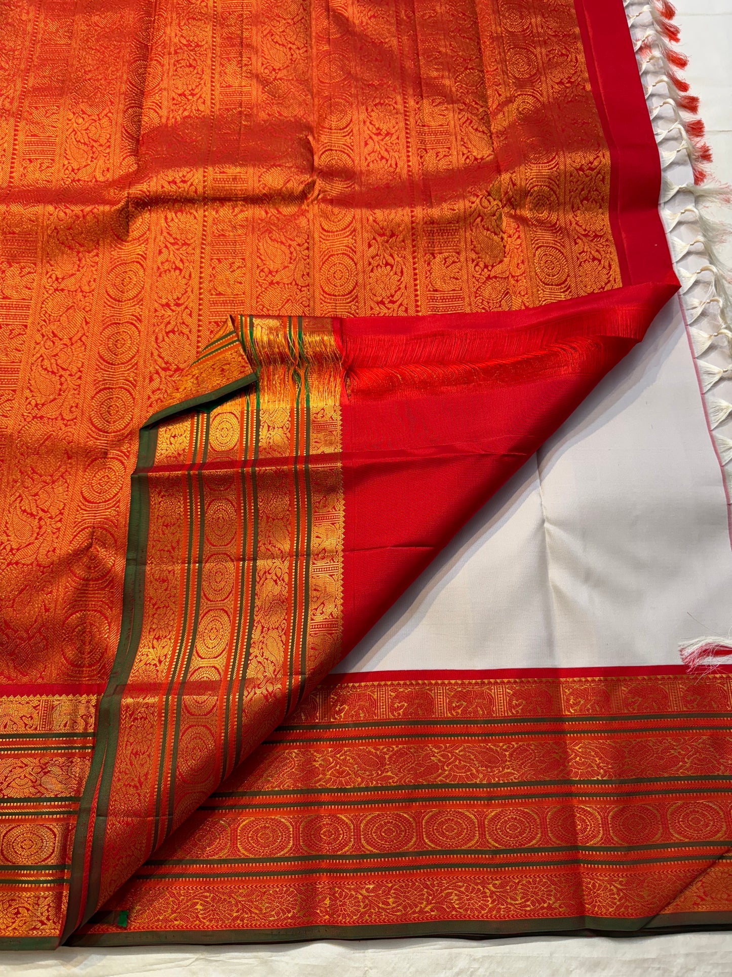 Zari pallu detail on Pure Kanchipuram Silk Saree with red border and tassels, shipped from New Jersey USA