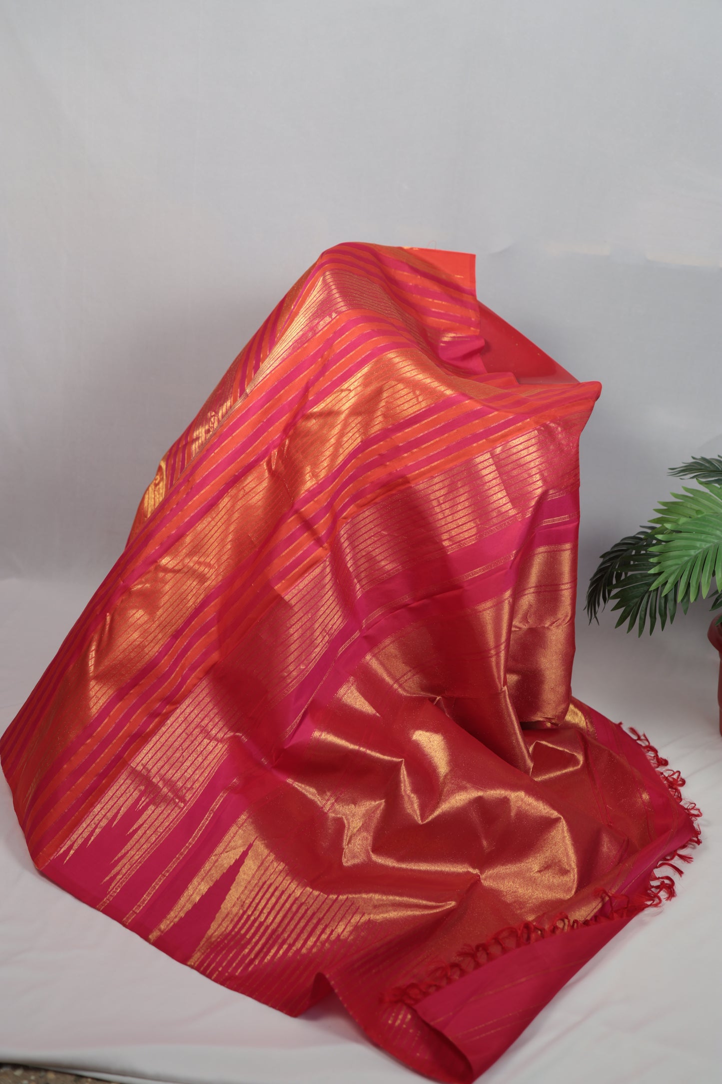 Pure Kanchipuram silk saree woven in Ettukol technique featuring antique gold zari structure across the silk body, photographed to highlight the architectural weave of the textile