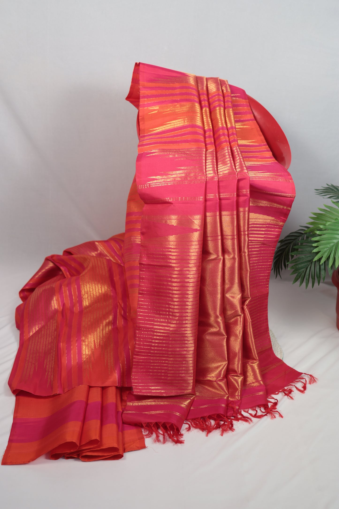 Pure Kanchipuram silk saree with Ettukol weaving displayed on a mannequin, showing the luminous silk body and classic gold zari work suitable for festive occasions
