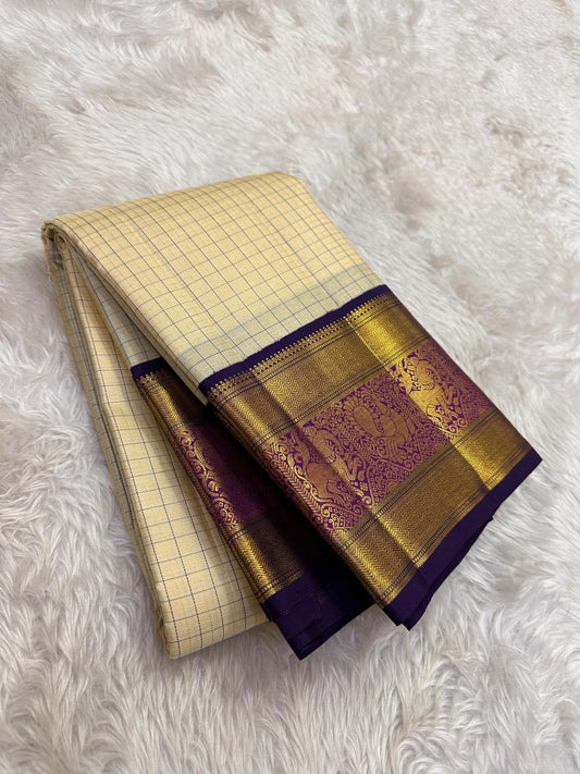 Cream beige Kanchipuram silk saree with indigo purple border folded view