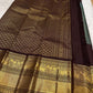 Folded green and brown Kanchipuram silk saree with classic zari work