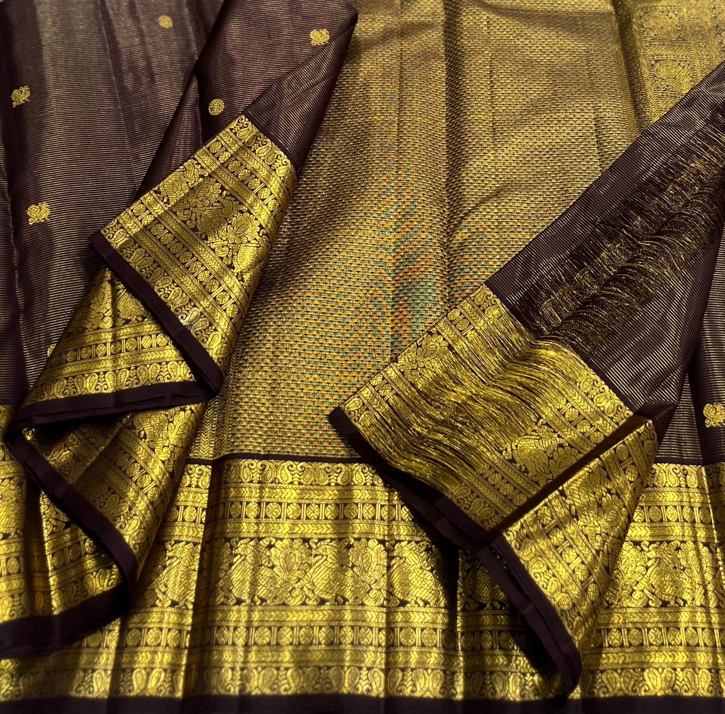 Deep cocoa brown Kanjivaram silk saree with antique gold pallu folded view