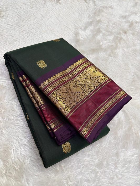 Deep pine green Kanchipuram silk saree with mulberry purple border folded view