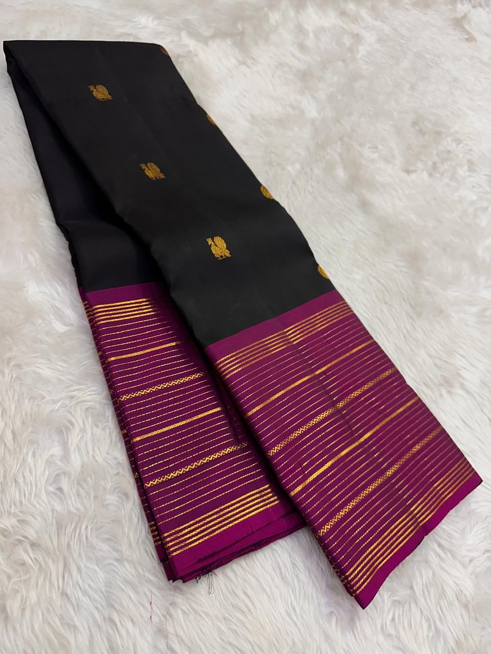 black kanjivaram silk saree fuchsia pink border draped festive styling