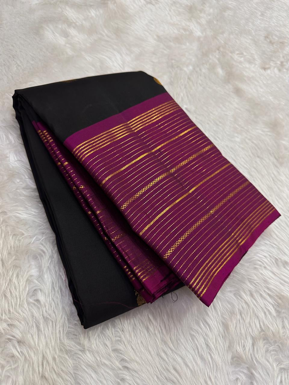 ebony black kanchipuram silk saree with mayil butta gold zari folded view
