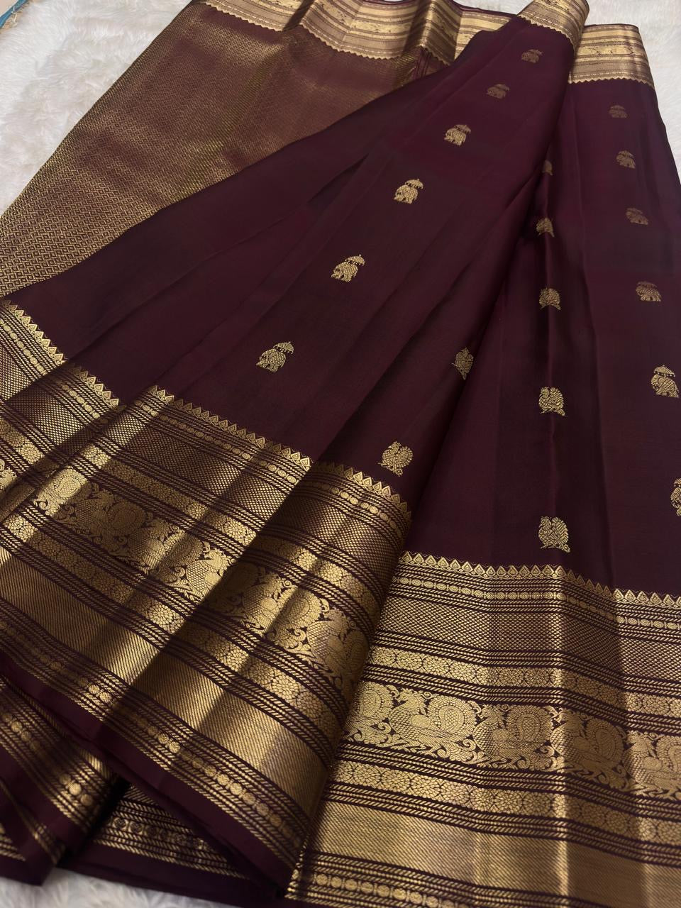 Espresso brown pure silk Kanchipuram saree with antique gold mayil chakram buttas, peacock-green detailing, and a detailed peacock and arai maadam pallu, view 3.