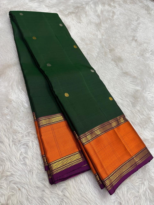 Kancheepuram silk saree green body with pavun butta and zari border detail
