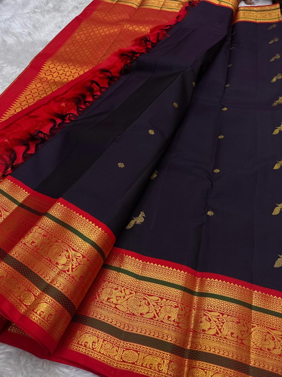 Kancheepuram silk saree mayil butta motifs on deep purple silk