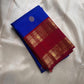 Folded Pure Kanchipuram silk saree in royal blue with a maroon zari woven border and a round silver motif on the fold.