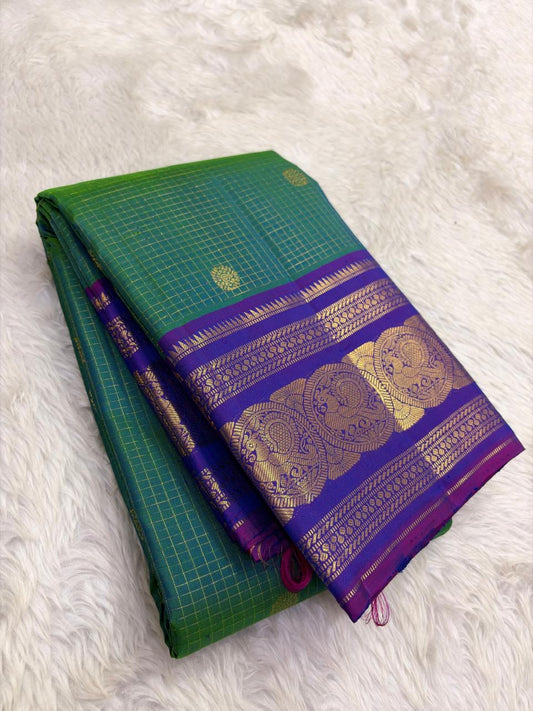 Green Kanjivaram silk saree with sorgavaasal mayil motifs and zari kattam border draped view