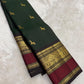 Deep green silk saree with gold buttas and red border draped view